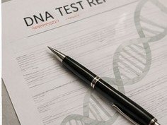 A DNA test report on a desk with a pen